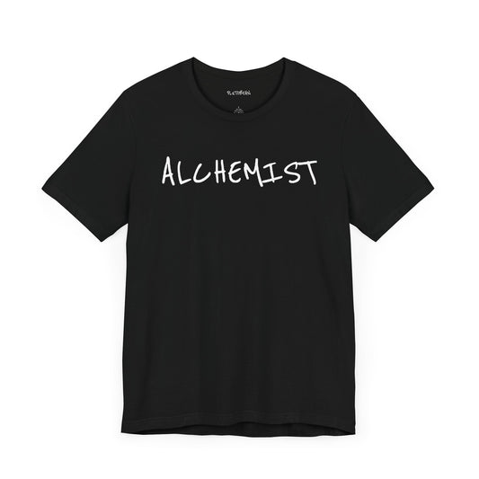 Black t-shirt with handwritten white “ALCHEMIST” text across the chest