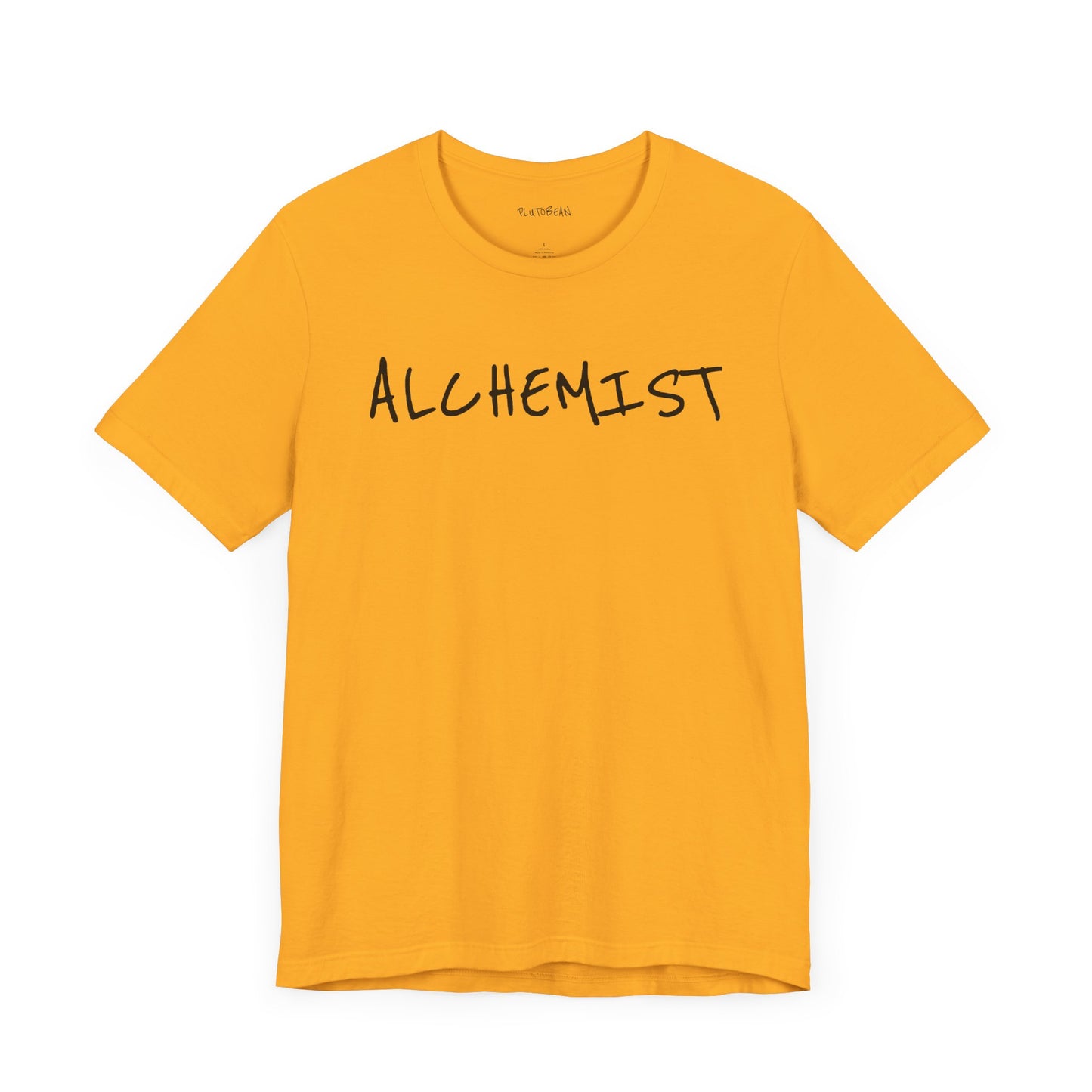 Gold t-shirt with handwritten black “ALCHEMIST” text across the chest