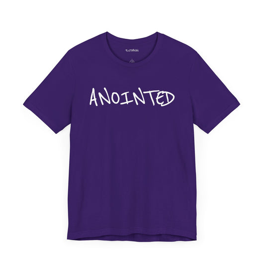 Purple t-shirt with handwritten white “ANOINTED” text across the chest