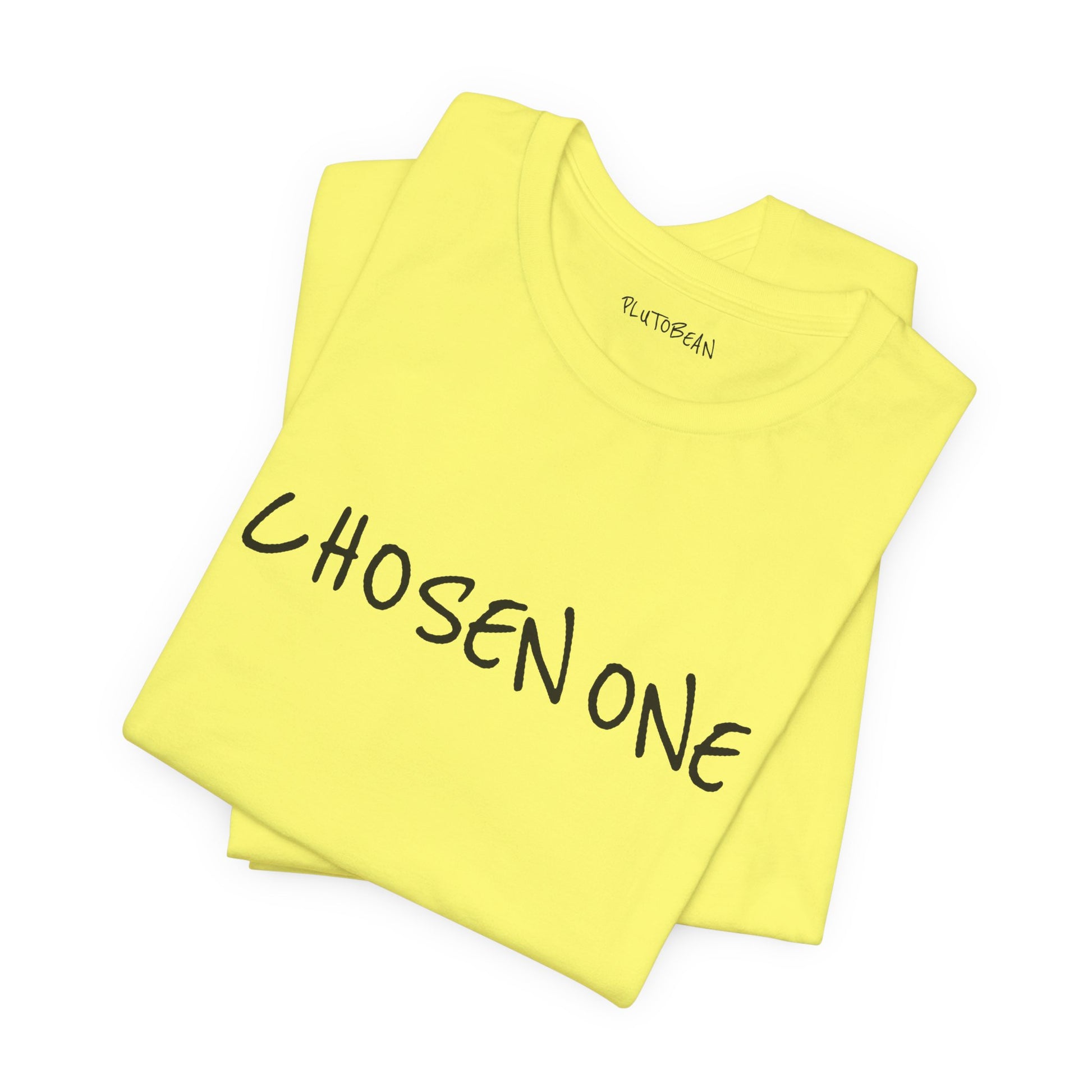 Folded yellow tee featuring bold handwritten “CHOSEN ONE” graphic in black