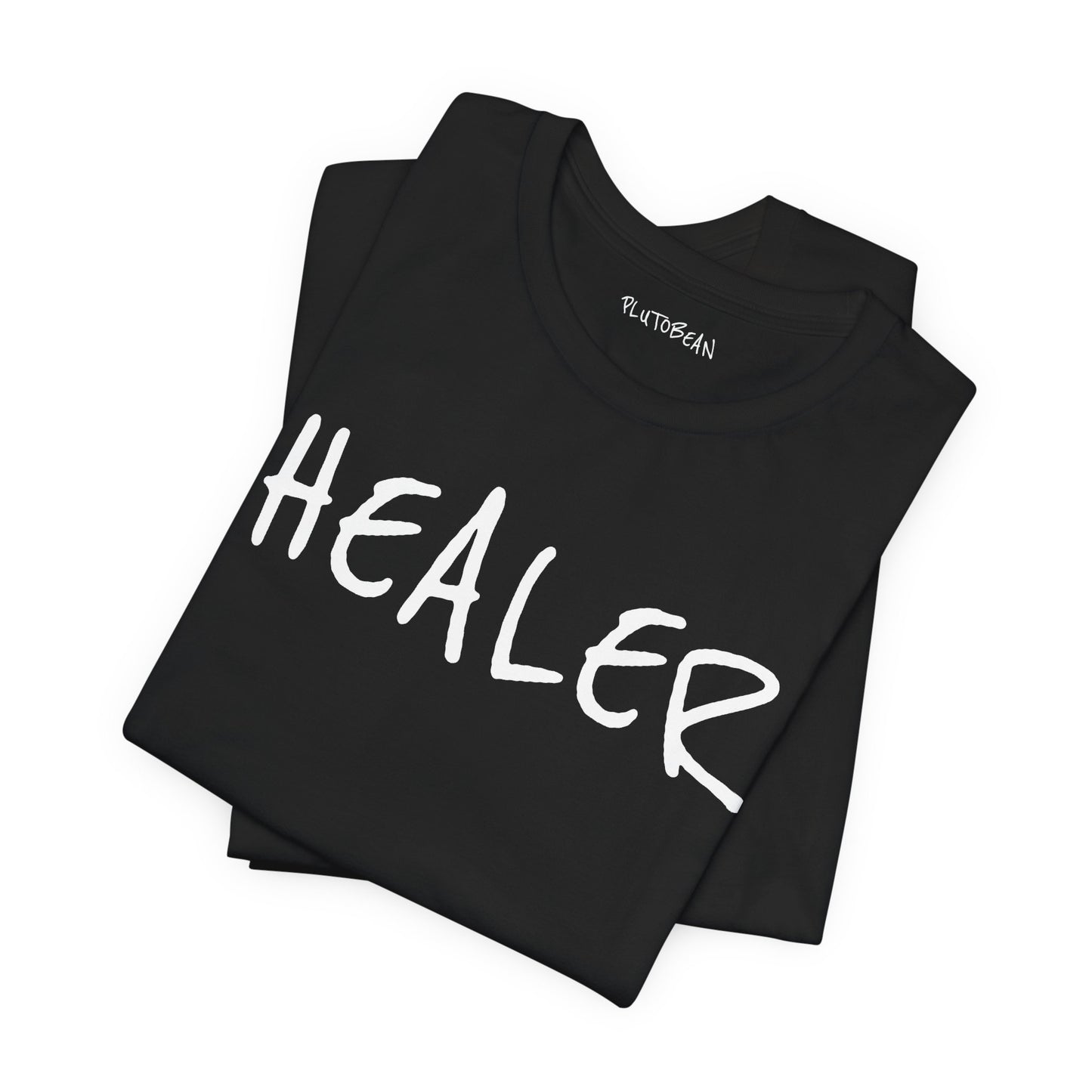 Folded black tee with bold handwritten “HEALER” graphic in white