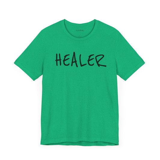 Heather Kelly green t-shirt with handwritten black “HEALER” text across the chest